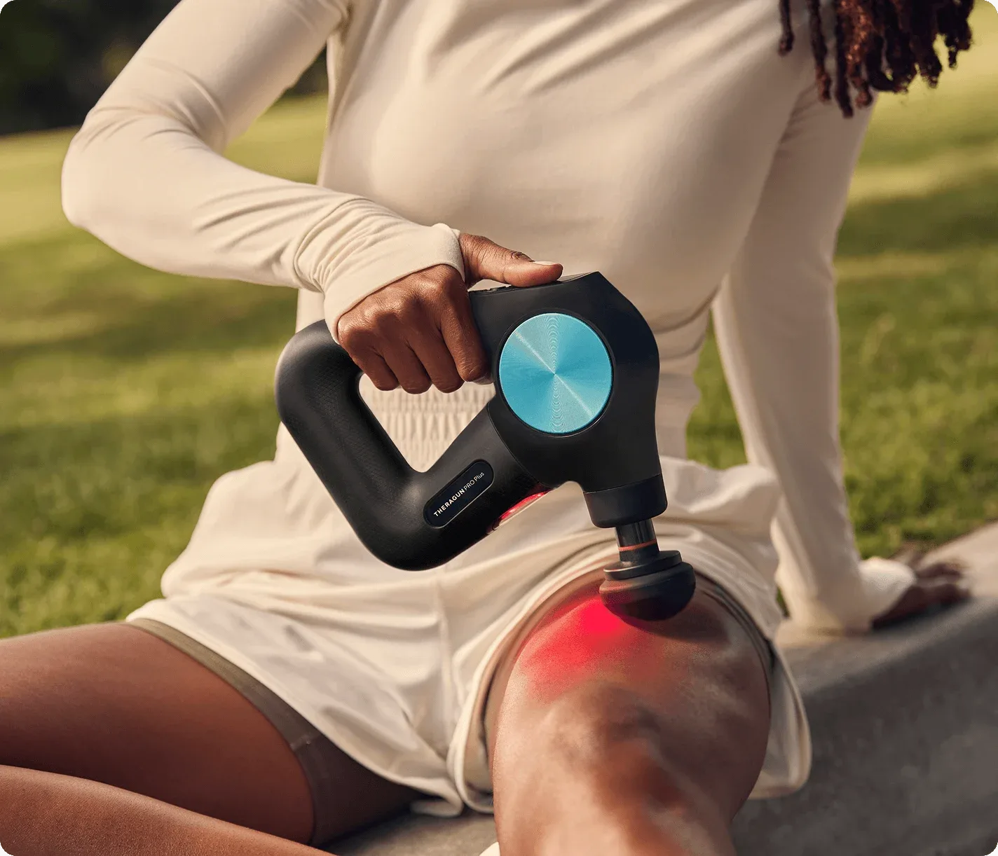 Theragun PRO Plus percussion massage gun on a dark background